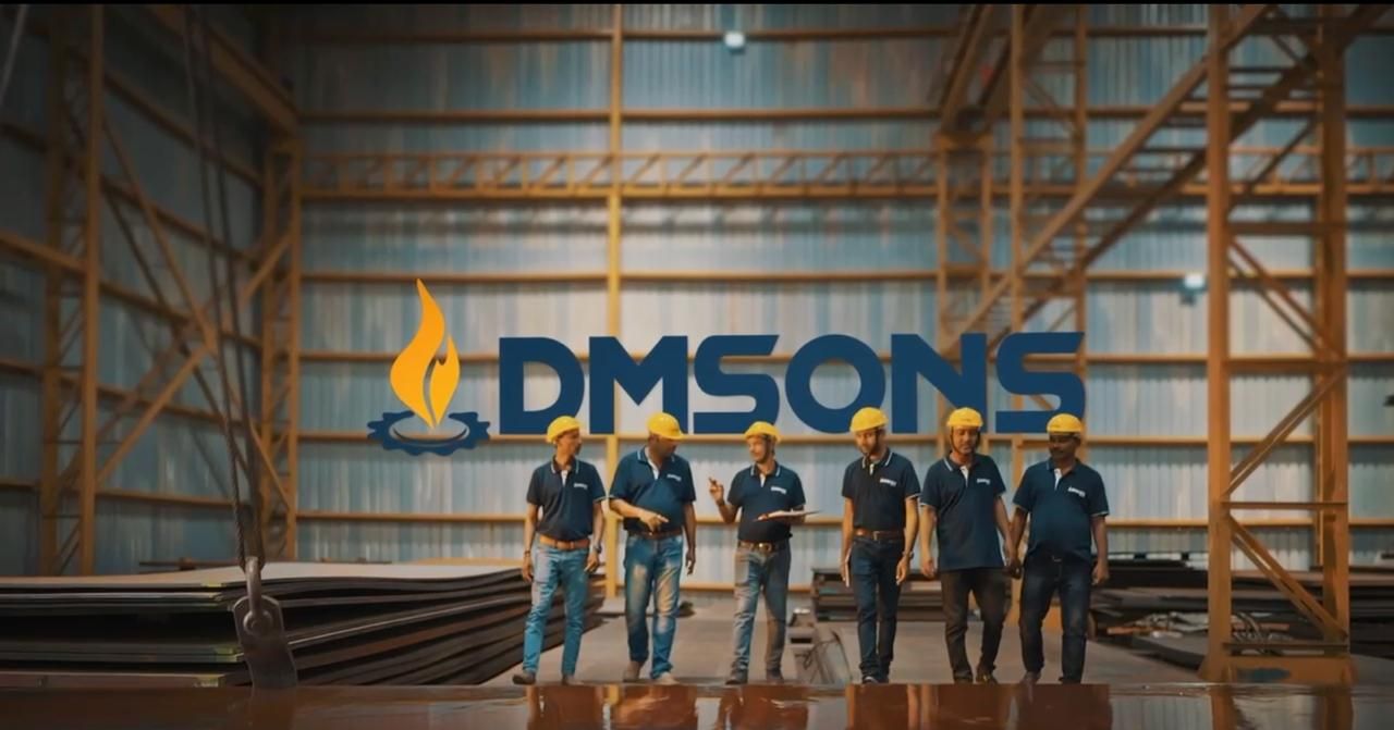 Dmsons Metal team in hard hats walking through the steel warehouse