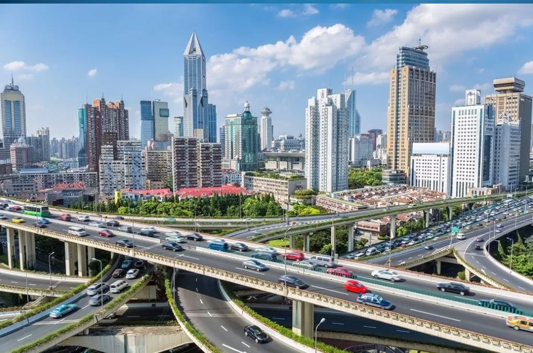 Highway interchange in front of a city skyline